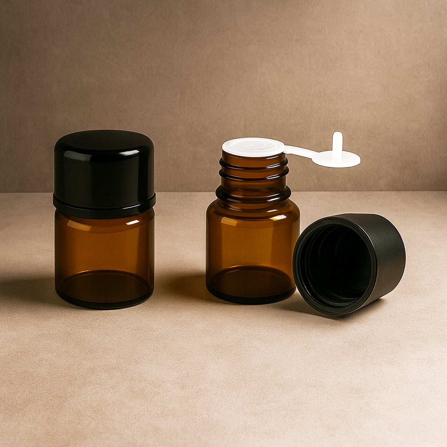 Amber glass bottles with black caps and resealable black-label pouches on a textured surface, minimalist luxury packaging for candles, essential oils, and home fragrance products.