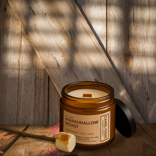 Luxury amber jar candle No. 206 Marshmallow Roast by Candl•ogic, with marshmallow, sugar, and smoke fragrance, styled on rustic wooden background with roasted marshmallow on a wooden stick.